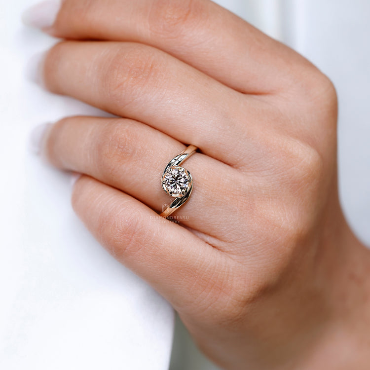 Six prong setting holds the round diamond securely.