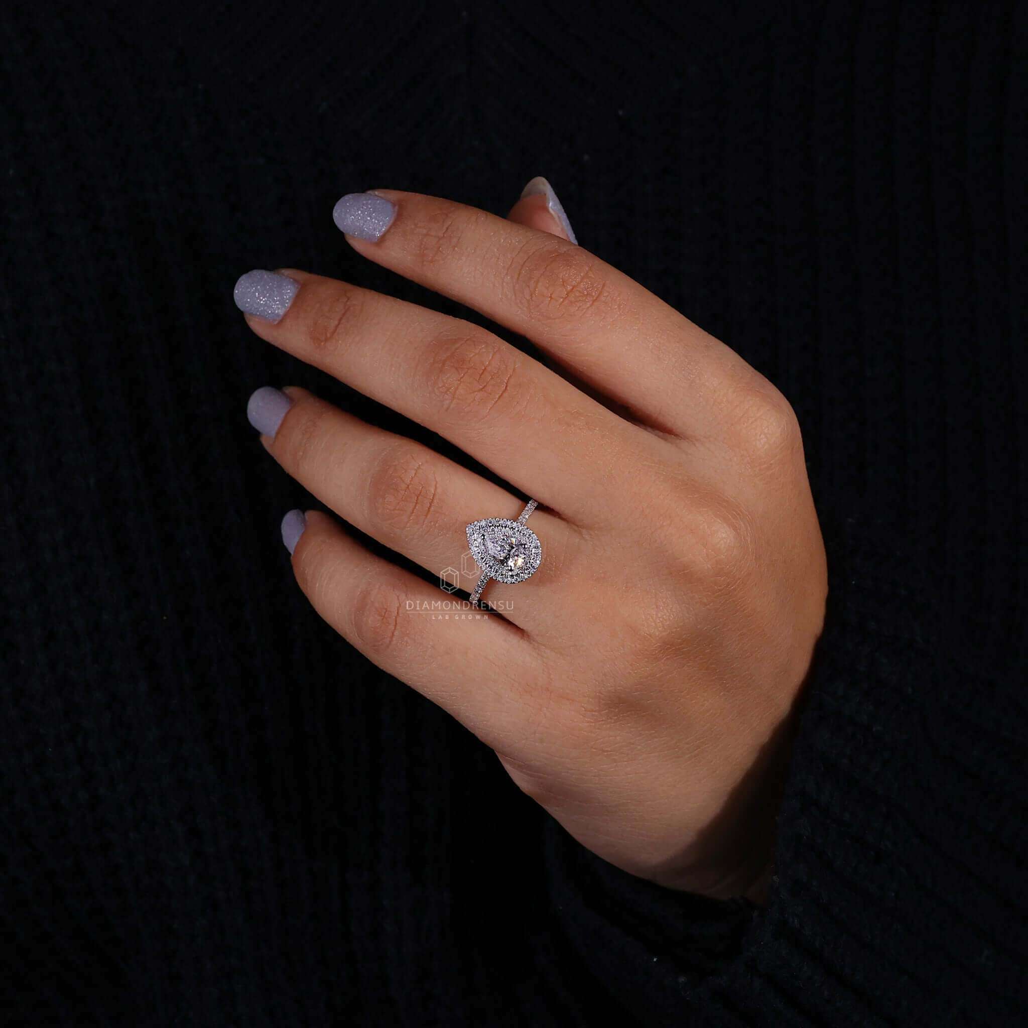 Pear diamond engagement ring paired with a halo diamond ring design for timeless beauty.