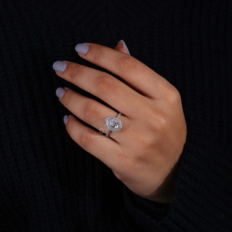 Pear diamond engagement ring paired with a halo diamond ring design for timeless beauty.