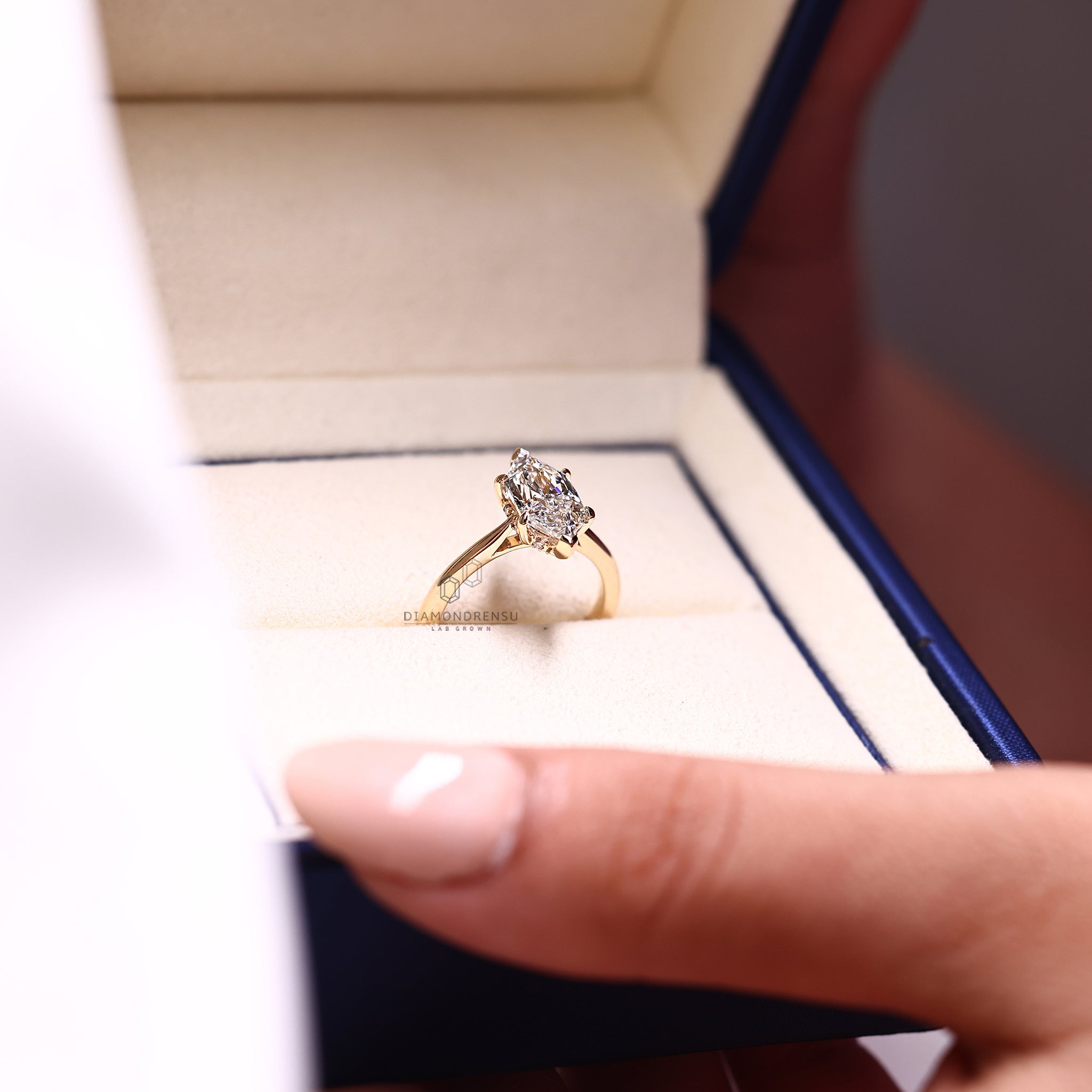 V prong setting ring holding a sparkling diamond.