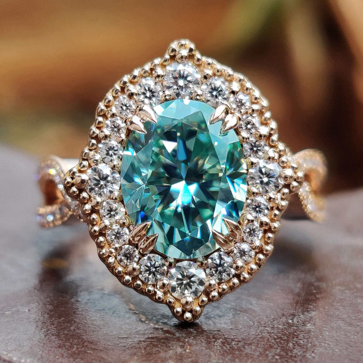 Oval engagement ring with rose gold band.