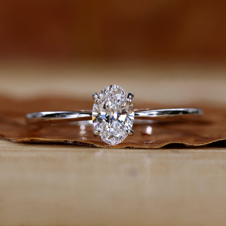 Oval solitaire engagement ring in white gold.