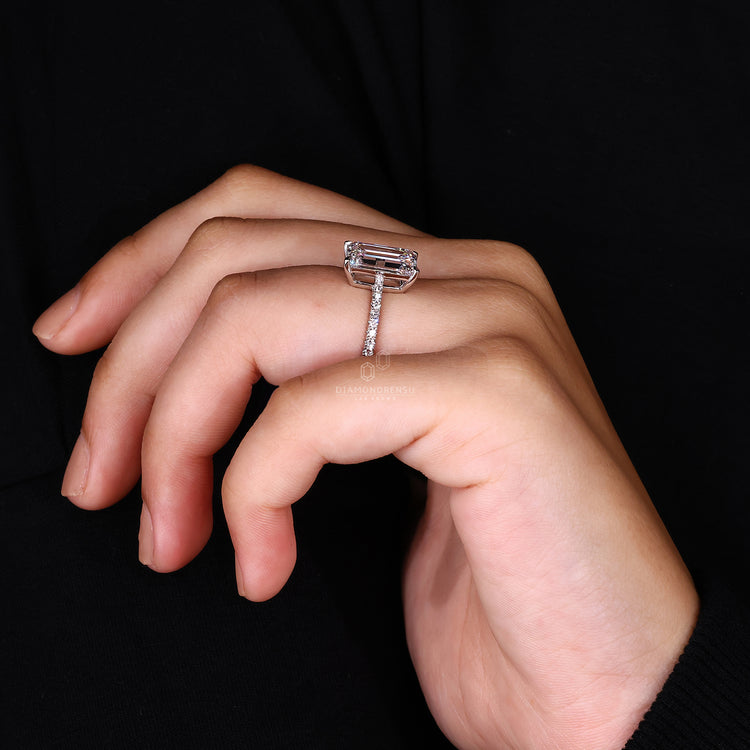 White gold engagement ring with emerald cut engagement ring.