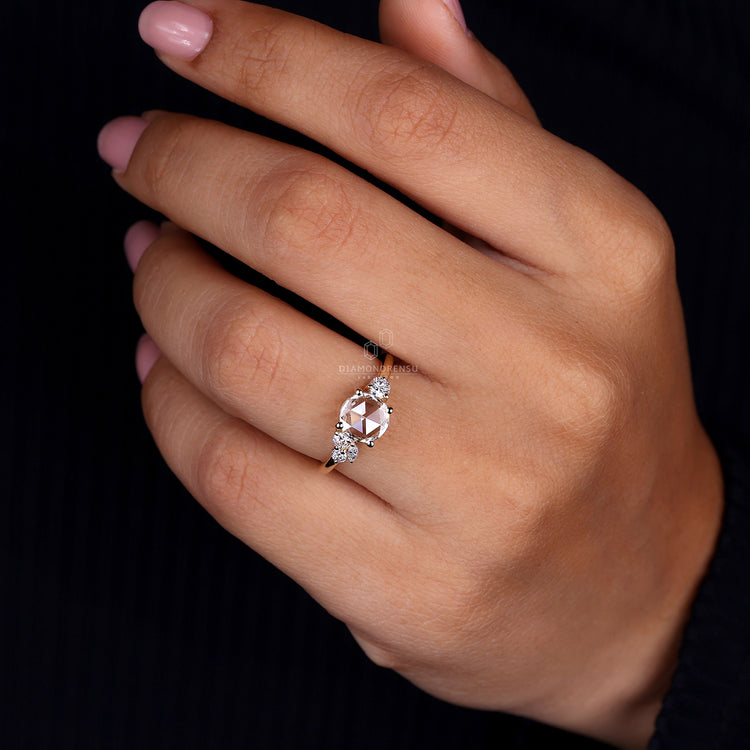 UK engagement ring features round and marquise diamond look.