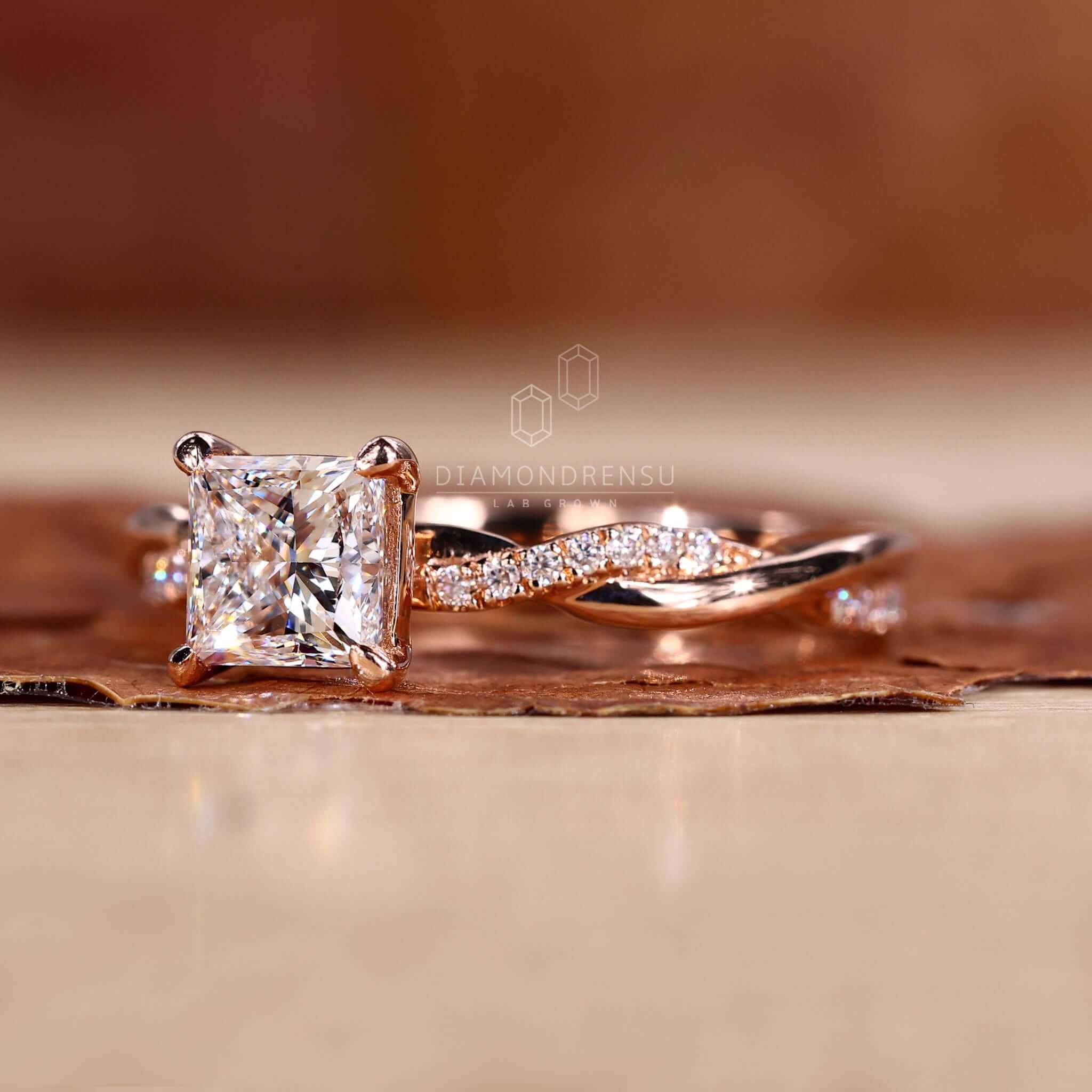 Engagement ring with side stones showcasing a 1 carat princess cut diamond ring for added sparkle.