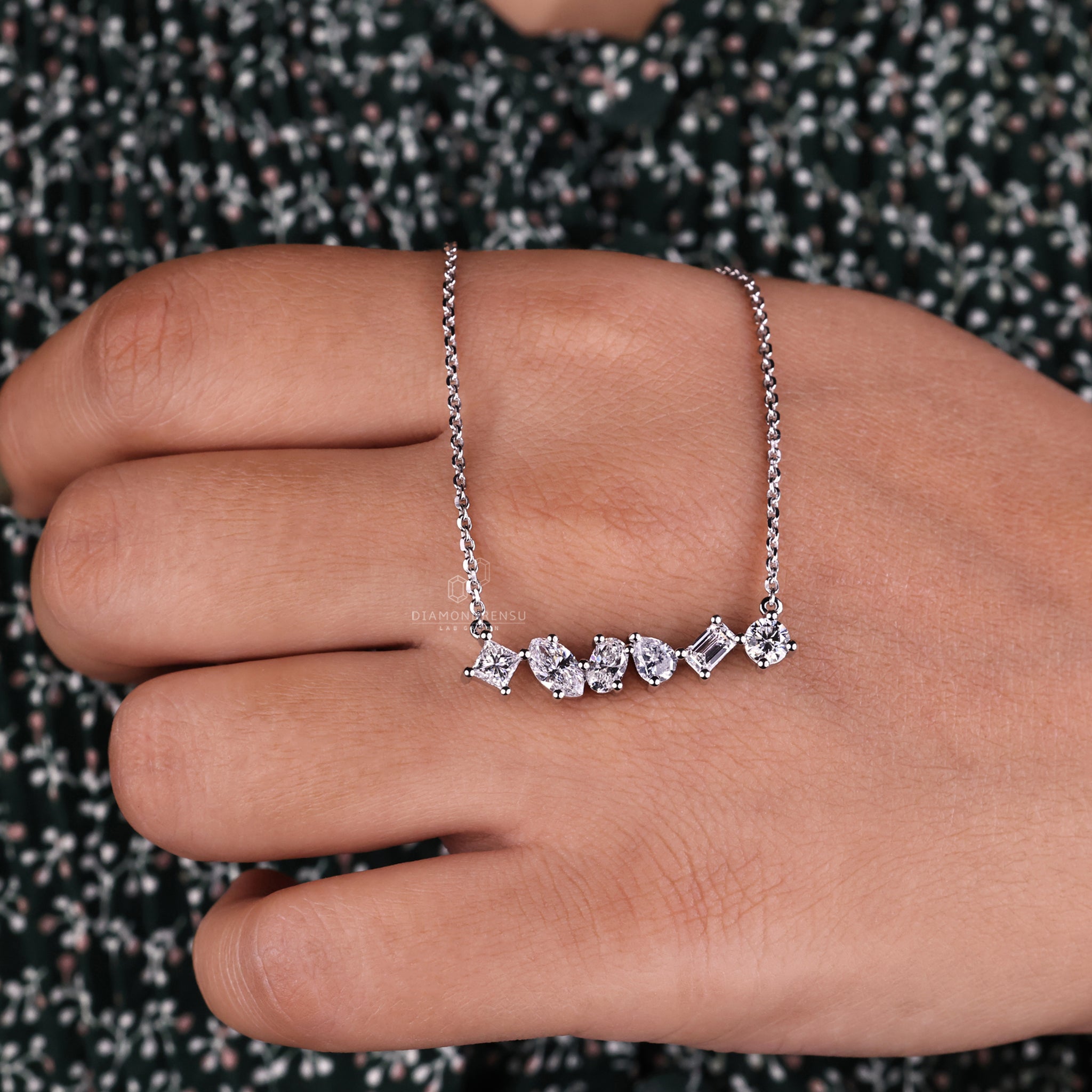 Diamondrensu UK pendant showcasing round, emerald, and princess cut diamonds.