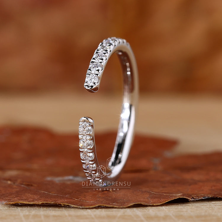 Open band wedding ring with round diamonds.