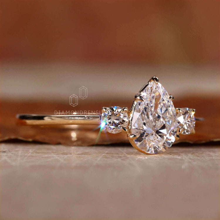 Pear shaped diamond ring in claw prong setting for lasting elegance.