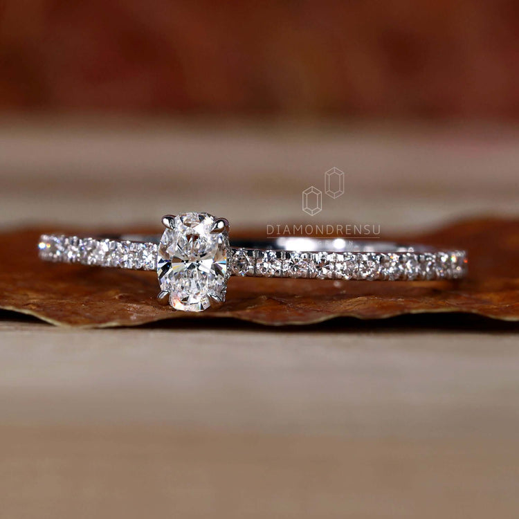 Oval diamond engagement ring with a hidden halo and pave diamond accents, perfect for women who love classic styles.