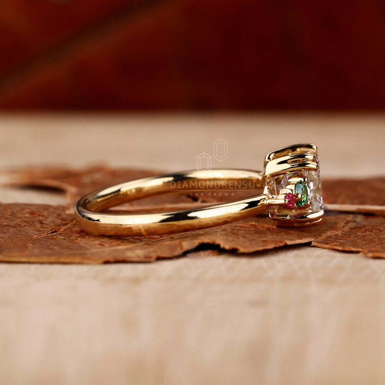 Princess cut engagement rings UK crafted with Lab Grown Diamond and green sapphire ring accents for modern sustainability.