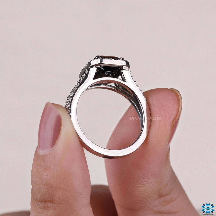 Emerald cut engagement ring with halo and pave in handmade white gold.
