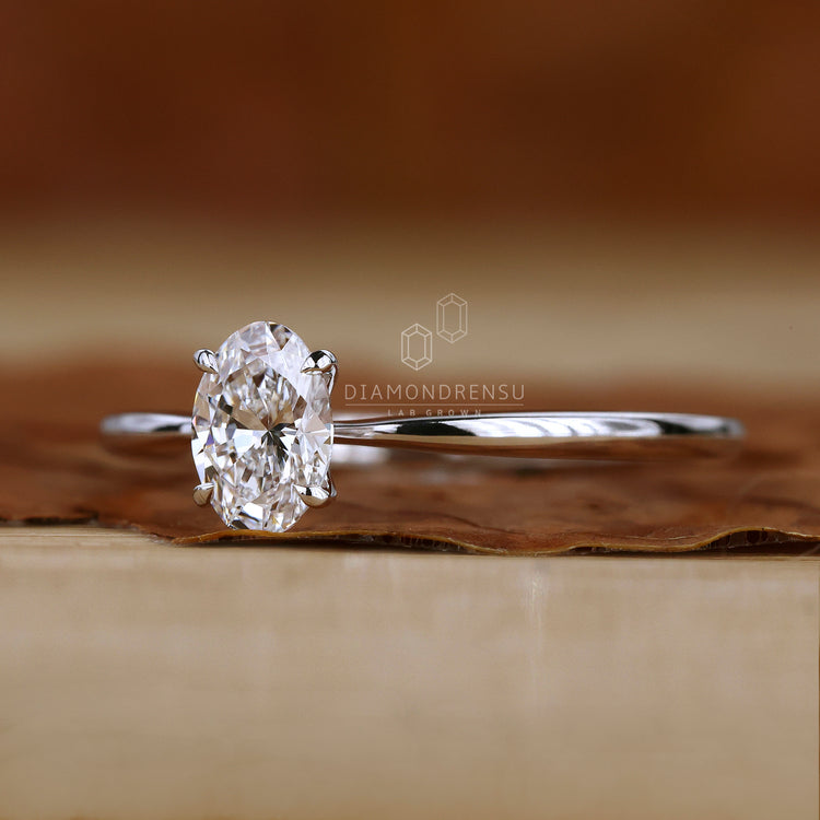 Tapered shank ring with oval solitaire stone.