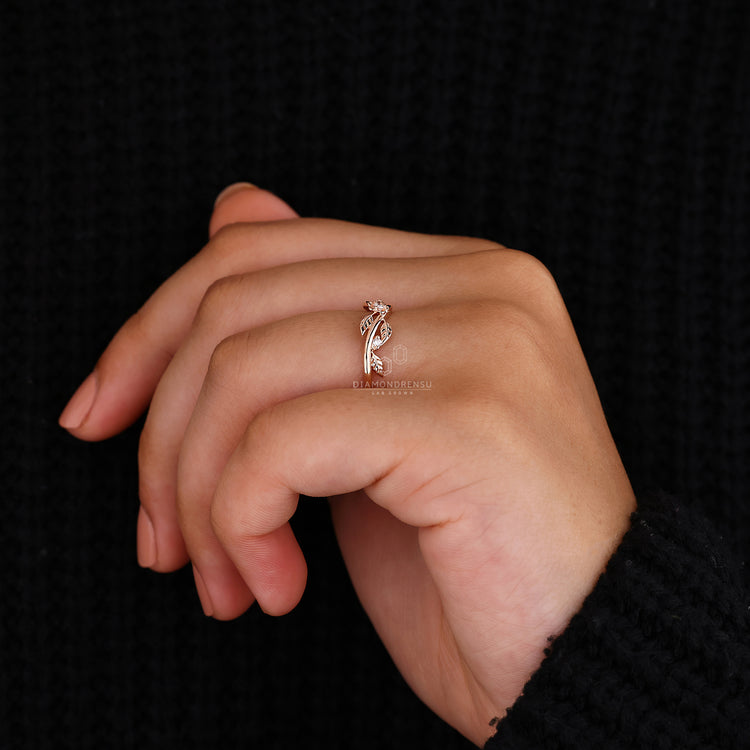 Prong set wedding band with nature inspired leaf design.