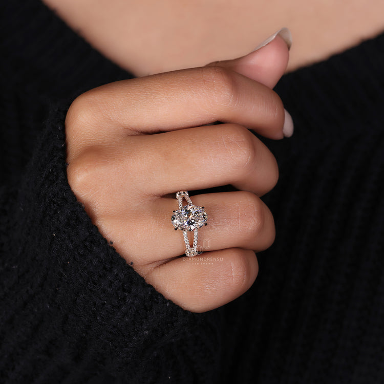 Oval cut diamond ring in a split shank pave engagement ring style.