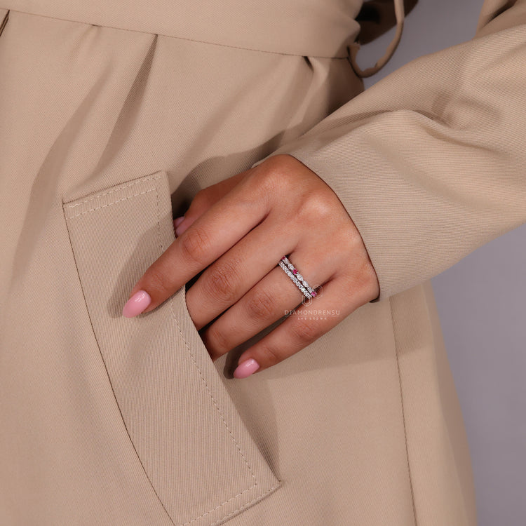 Prong set wedding band with lab grown stones in a sleek design.