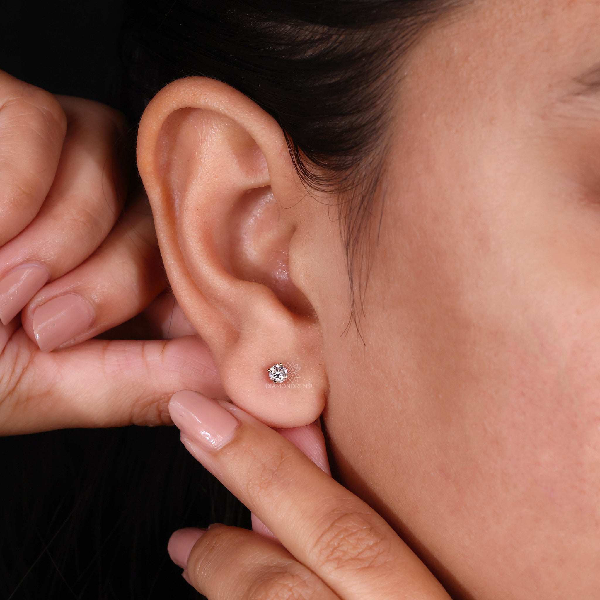 Gold stud earrings with lab diamonds.
