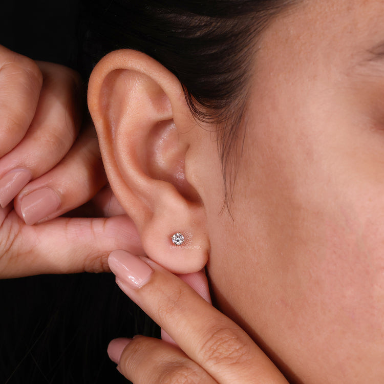 Gold stud earrings with lab diamonds.