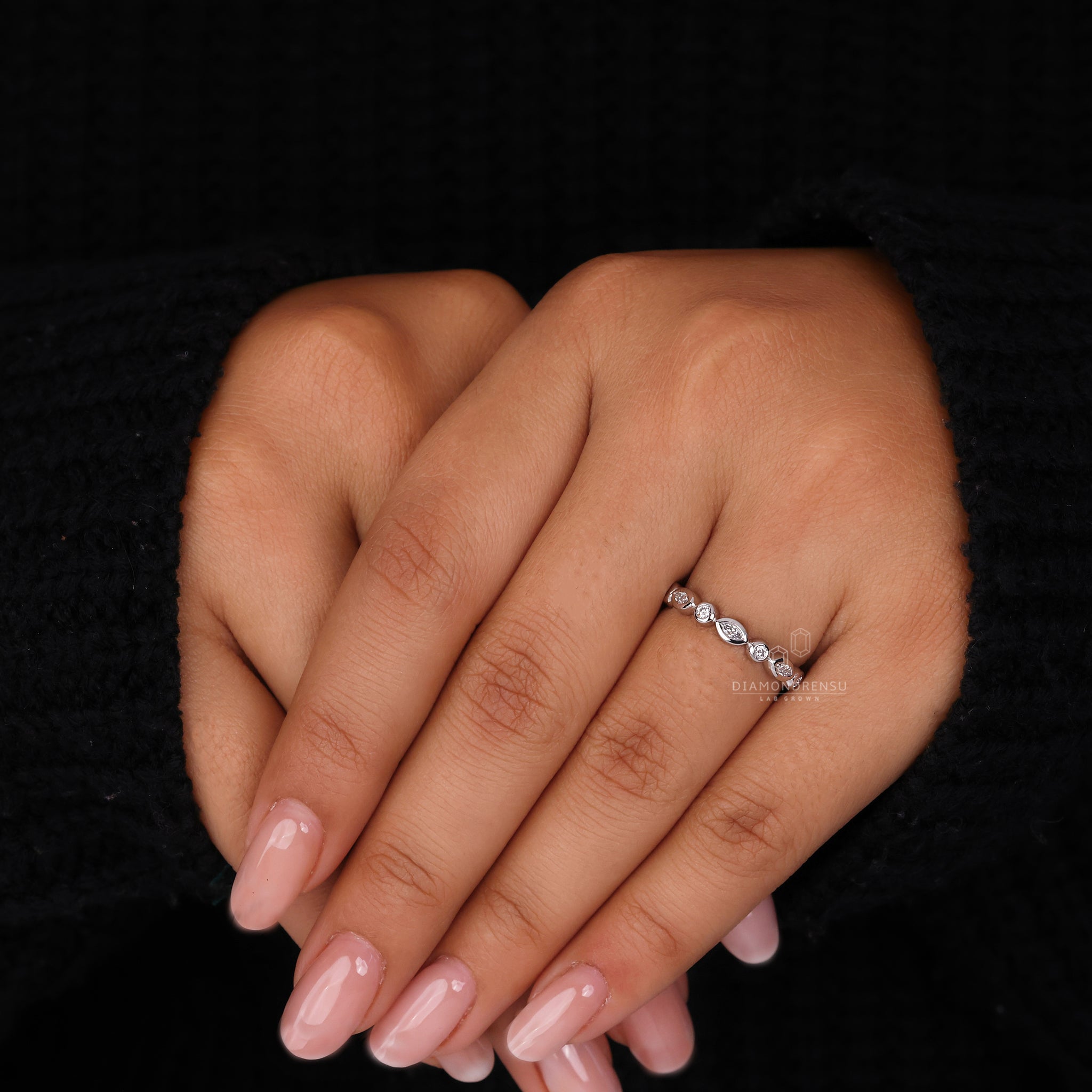 White gold wedding band designed with lab grown marquise and round stones.