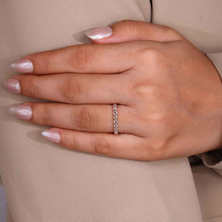 Eternity band with shared prong diamonds and UK design.