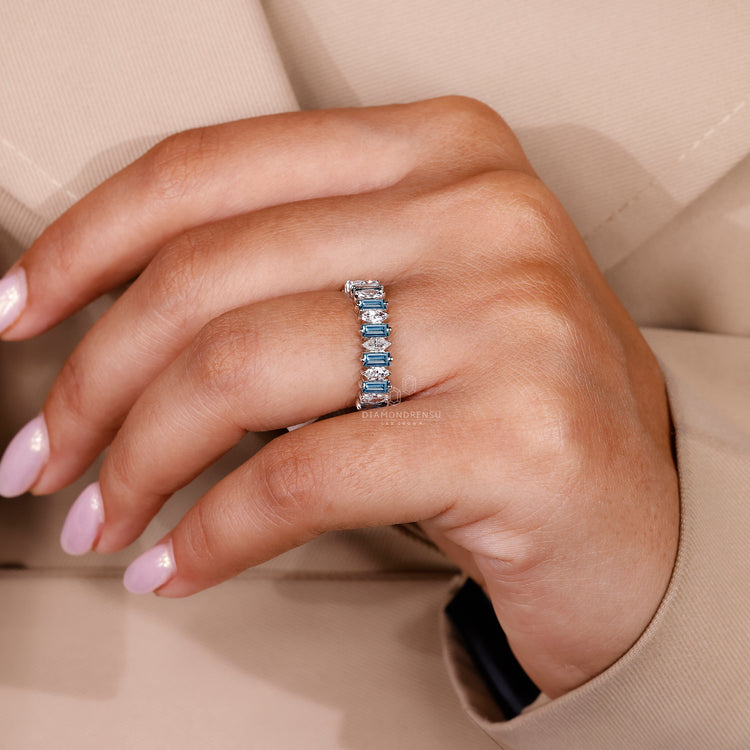 Simple wedding band designed with blue baguette stones and lab grown diamonds.