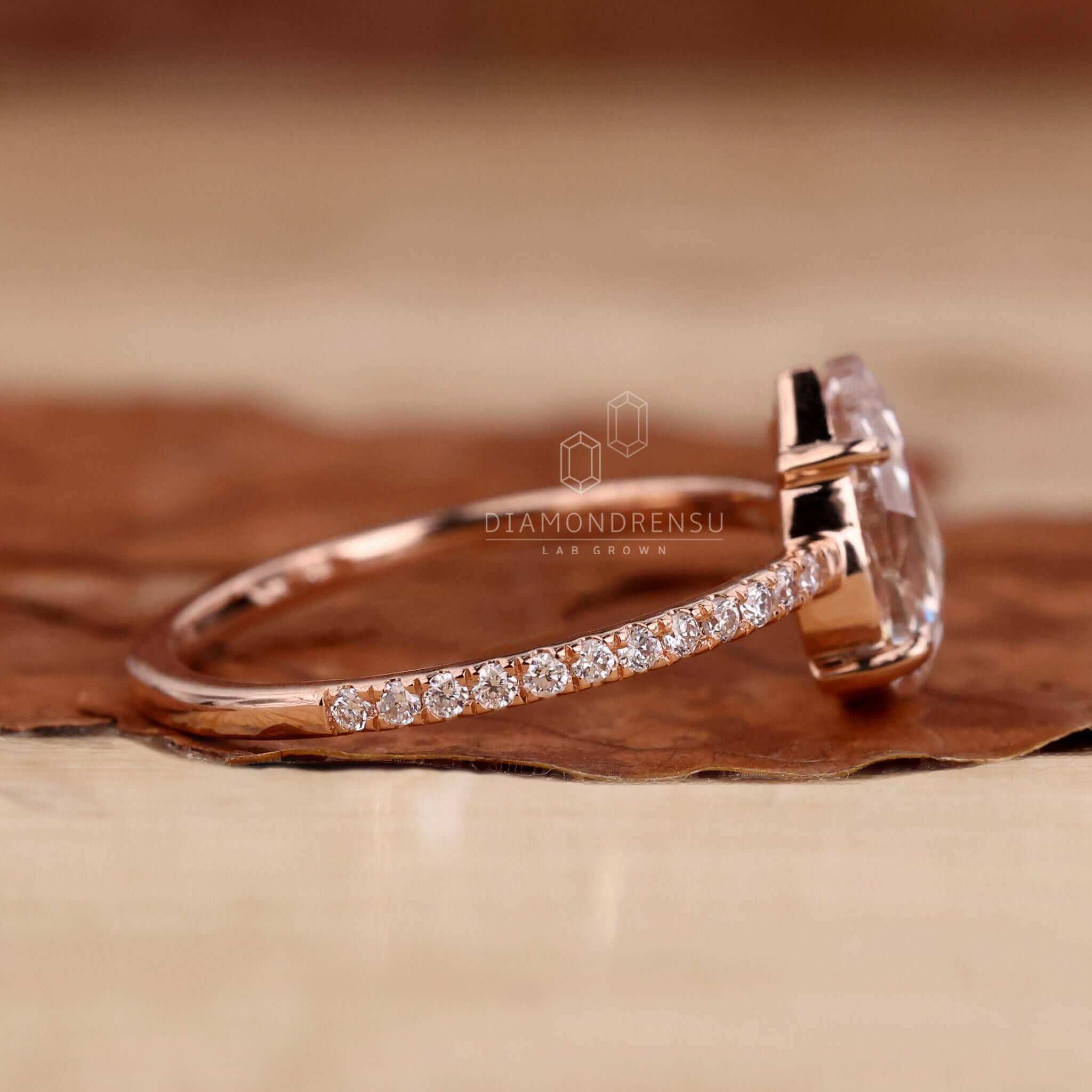 Pear shaped engagement ring with a stunning pave diamond ring setting for added brilliance.