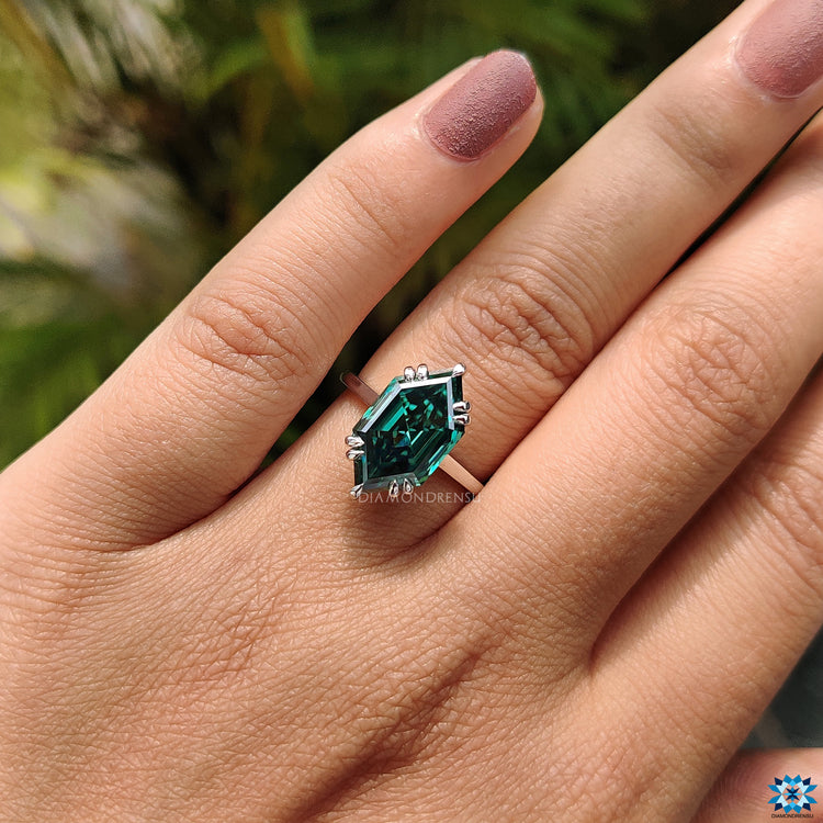 Moissanite engagement ring with hidden halo and striking green centre.