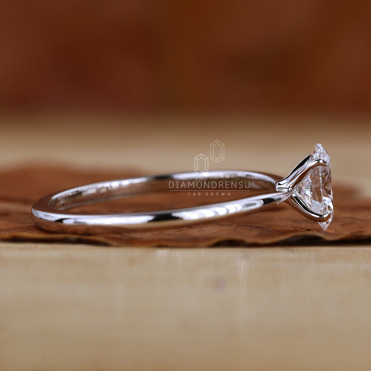 Oval diamond ring with claw prong setting.