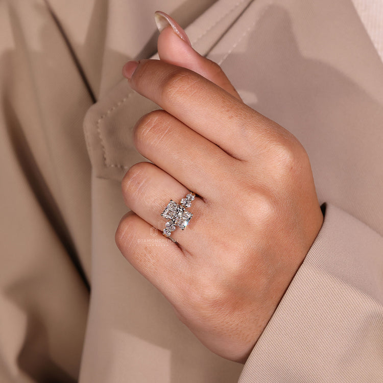 Round cut engagement ring is placed with radiant diamond.