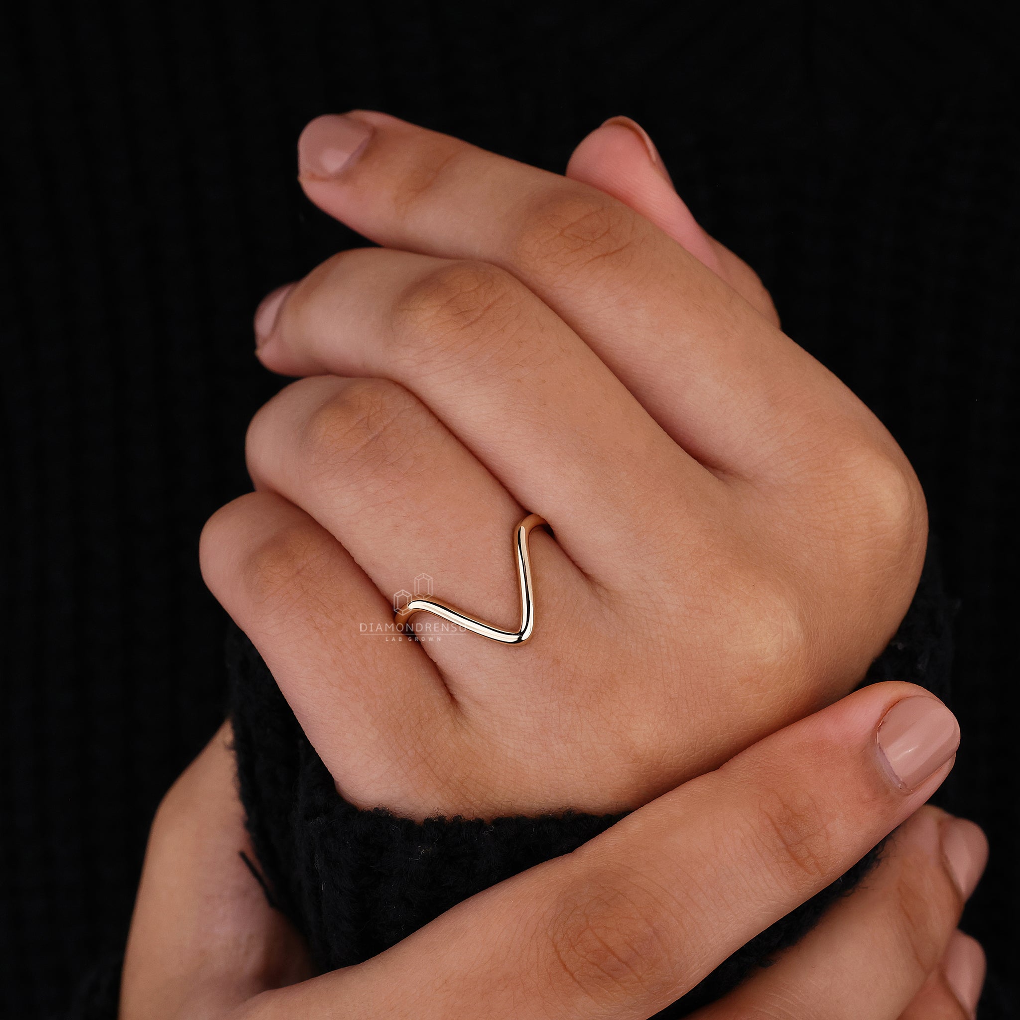 Curved wedding band with a sleek chevron point for stacking.