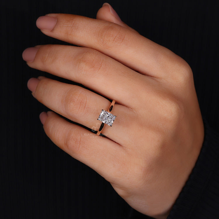 Princess cut hidden accent under radiant stone.