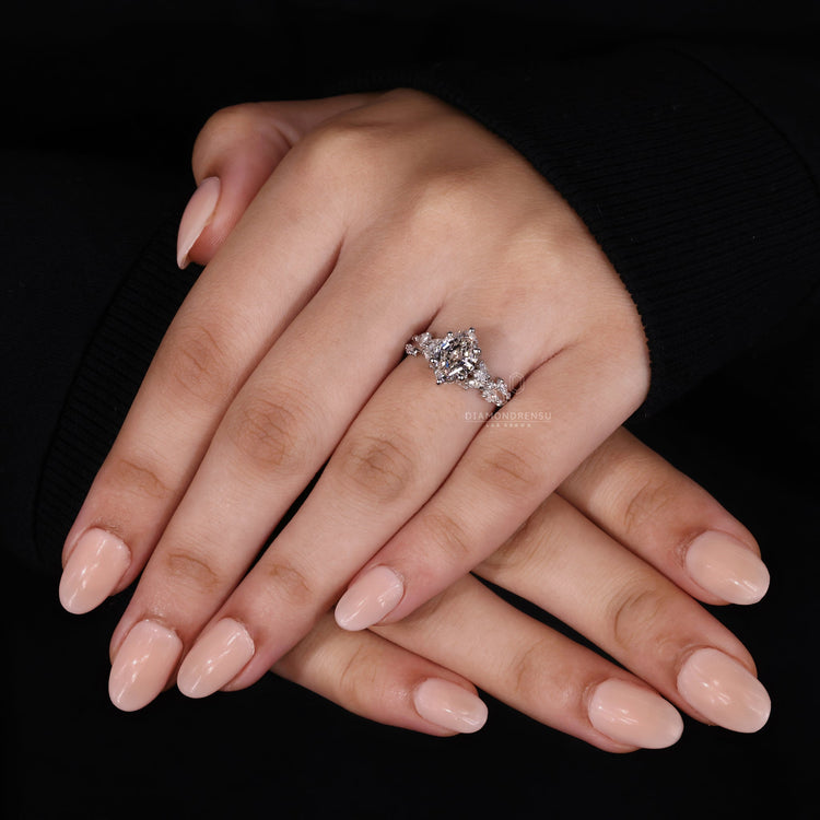 Lab grown diamond ring with marquise and round side stones.