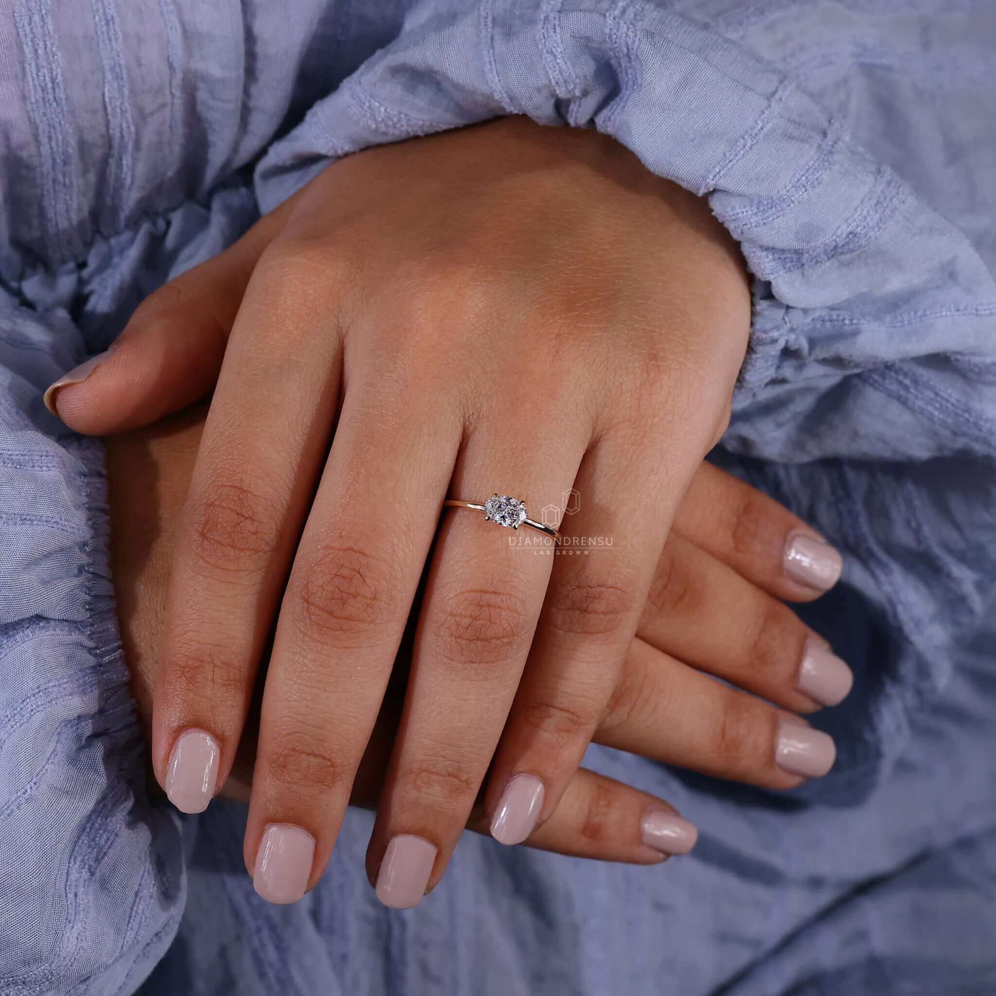 Oval engagement ring crafted with a solitaire diamond ring in a claw prong engagement ring design for modern style.