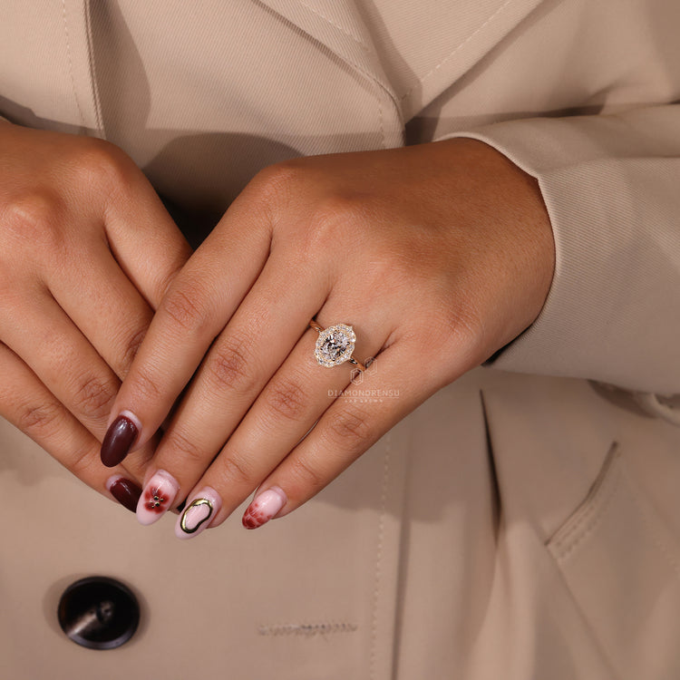 UK engagement ring features a handmade oval and round halo diamond look.
