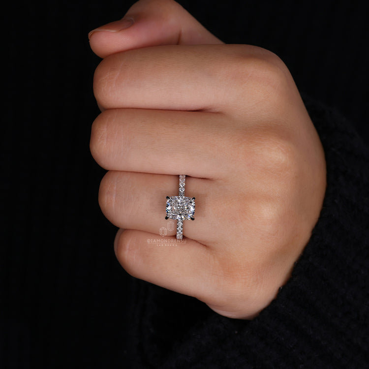 Custom engagement ring with pave setting and four claw prong ring.