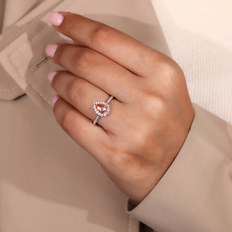 White gold diamond ring with round cut halo and claw prong setting.