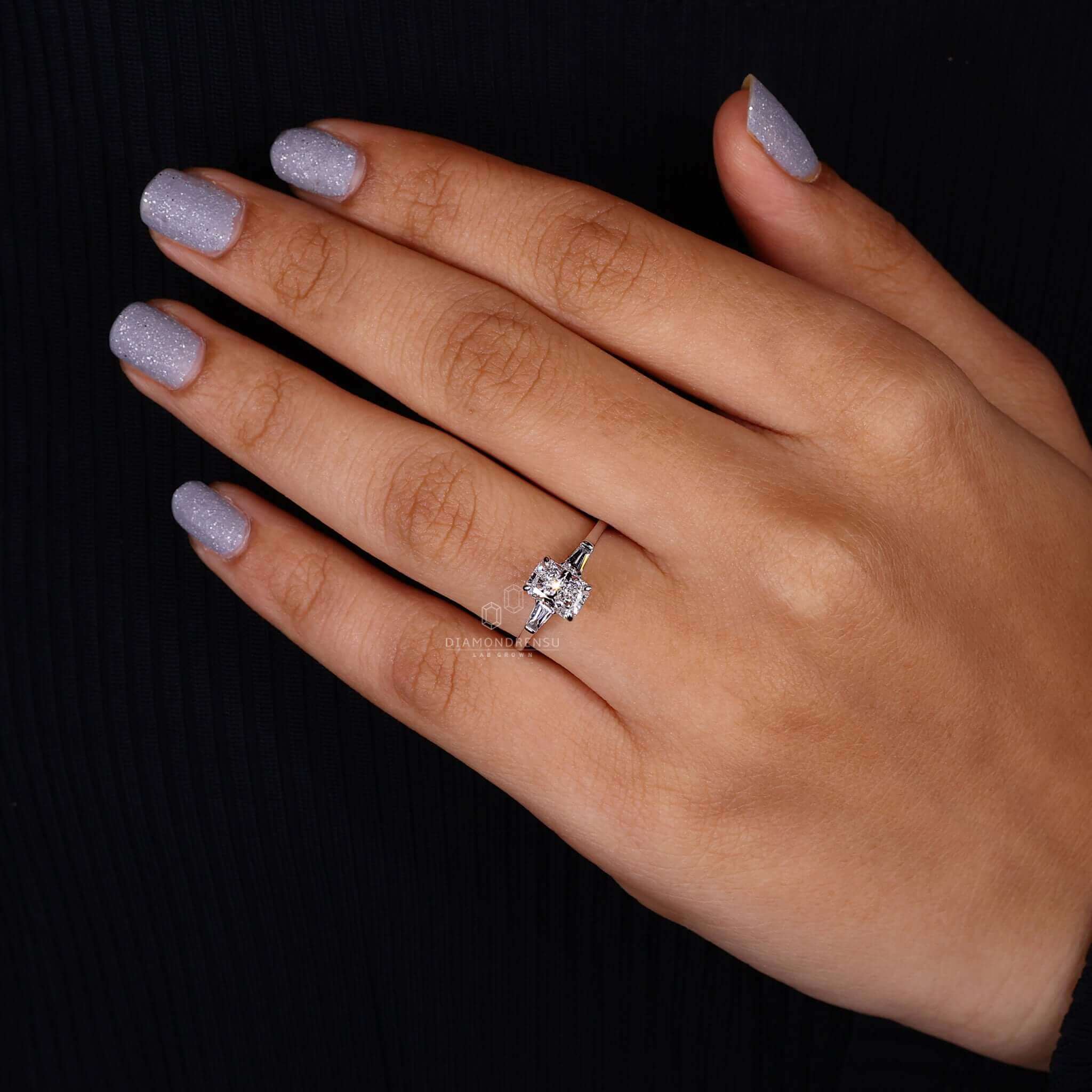 White gold ring showcasing a radiant cut diamond and baguette accents.