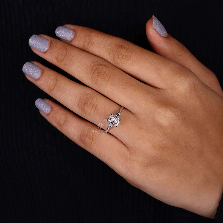White gold ring showcasing a radiant cut diamond and baguette accents.