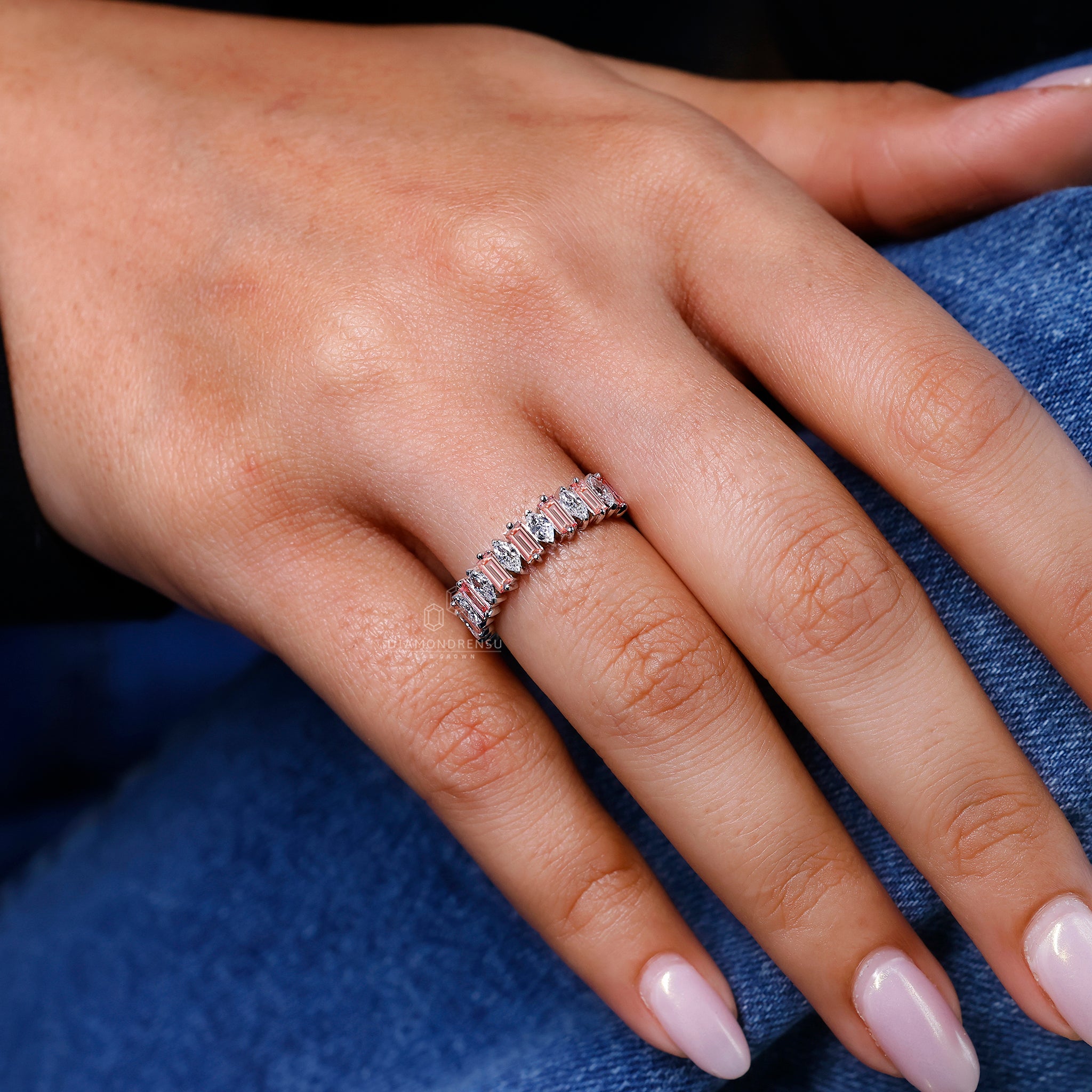 Pink baguette diamond band set in white gold with prong setting.