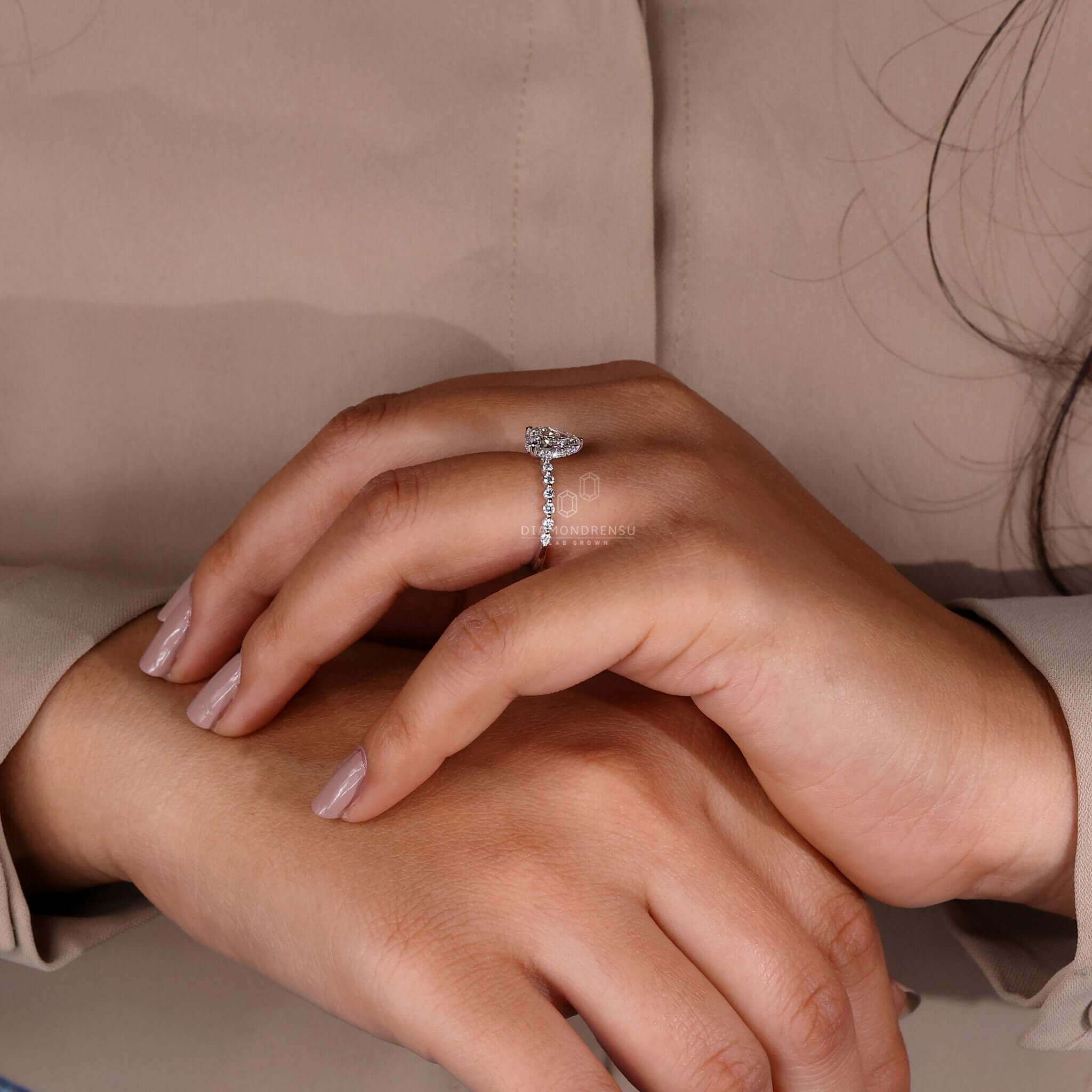 Round diamond ring featuring pave accents and a classic prong setting for a timeless look.