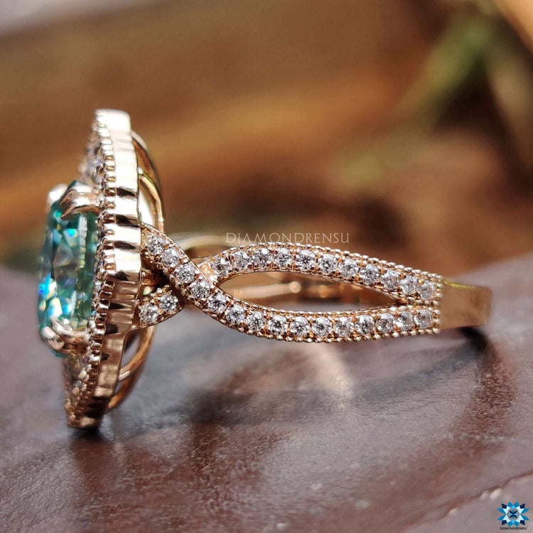 Round moissanite accent stones on halo ring.