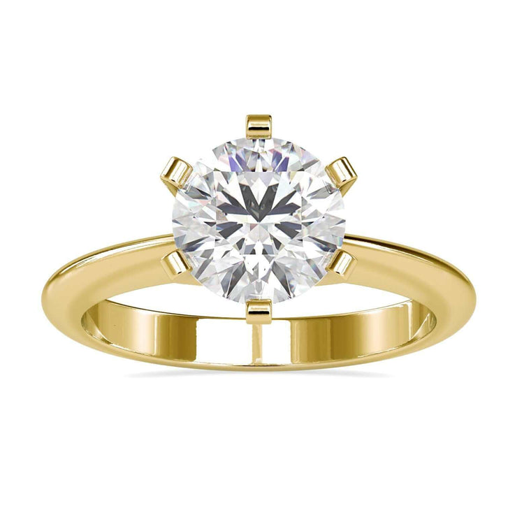 Gold solitaire engagement ring with round cut diamond in six prong setting.