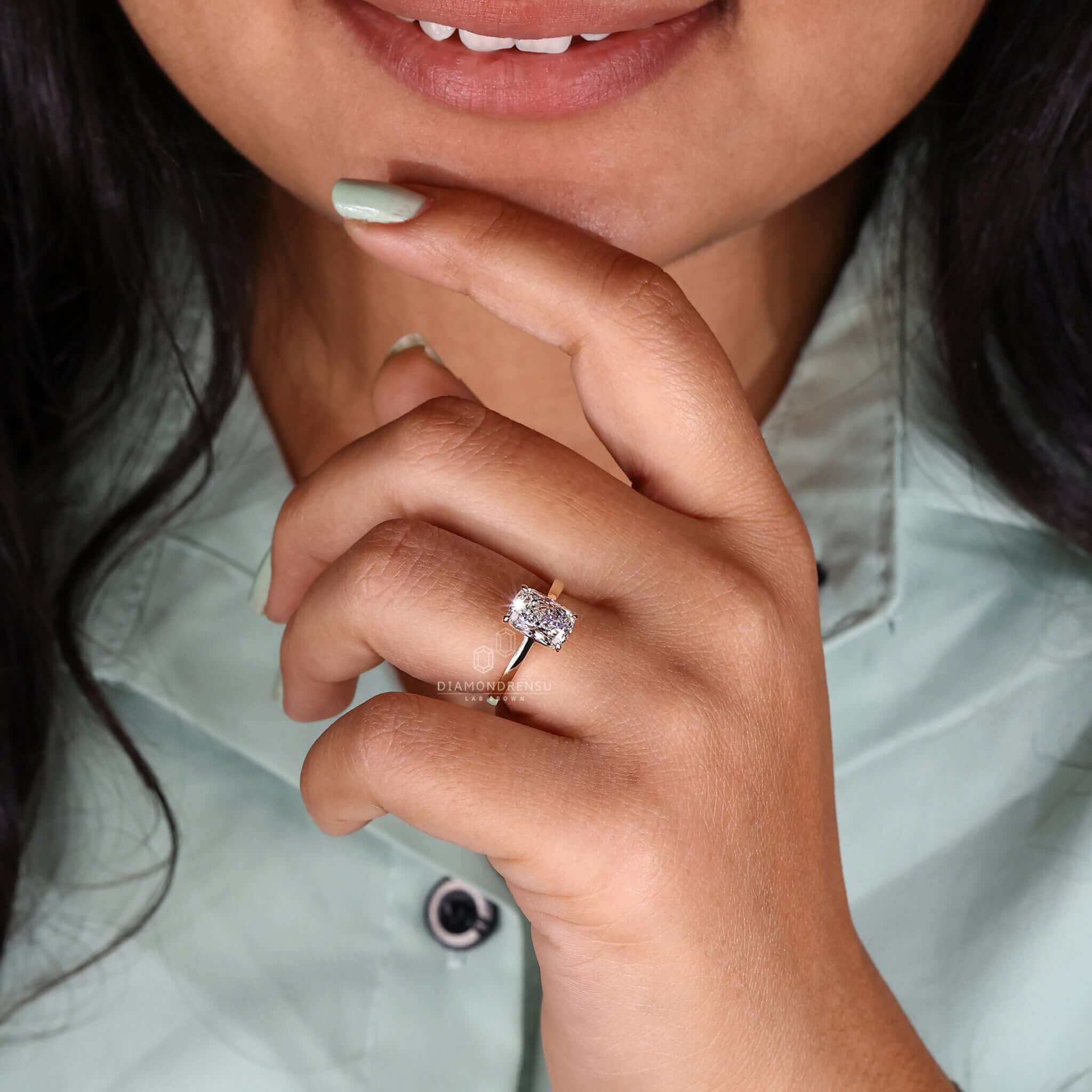 Handmade elongated cushion engagement ring with a 4-prong claw setting.