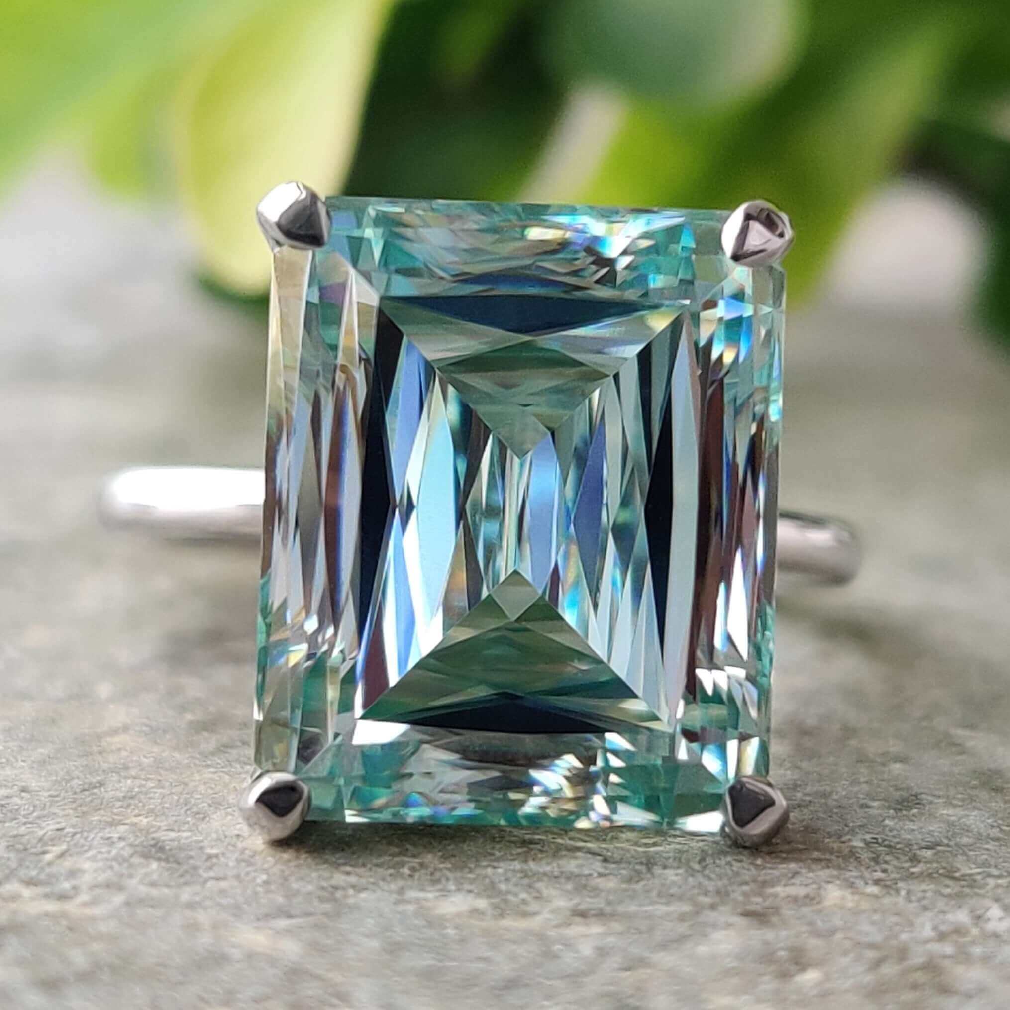 Criss cut ring featuring a cyan blue moissanite in a solitaire setting.