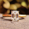 Emerald cut moissanite solitaire ring.