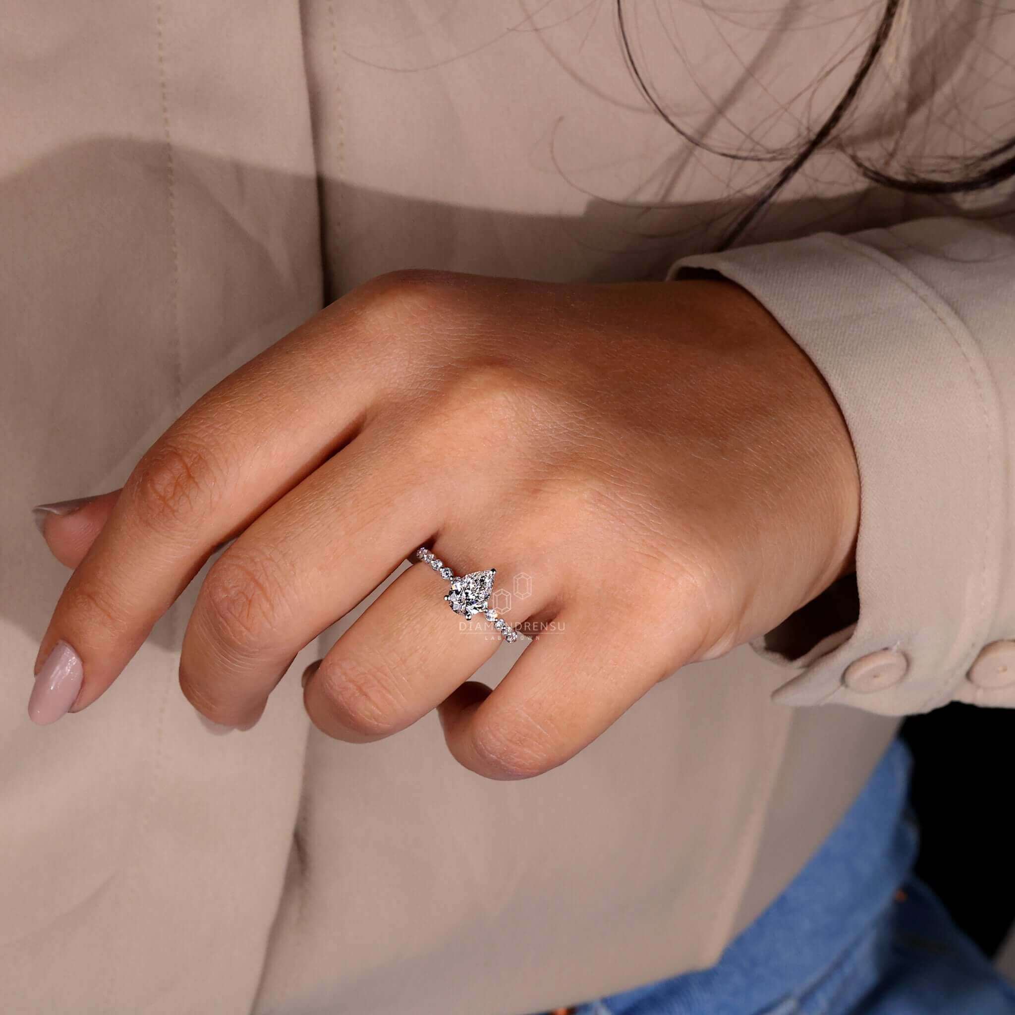 Hidden halo engagement ring designed to enhance the sparkle of a pear diamond centre stone.
