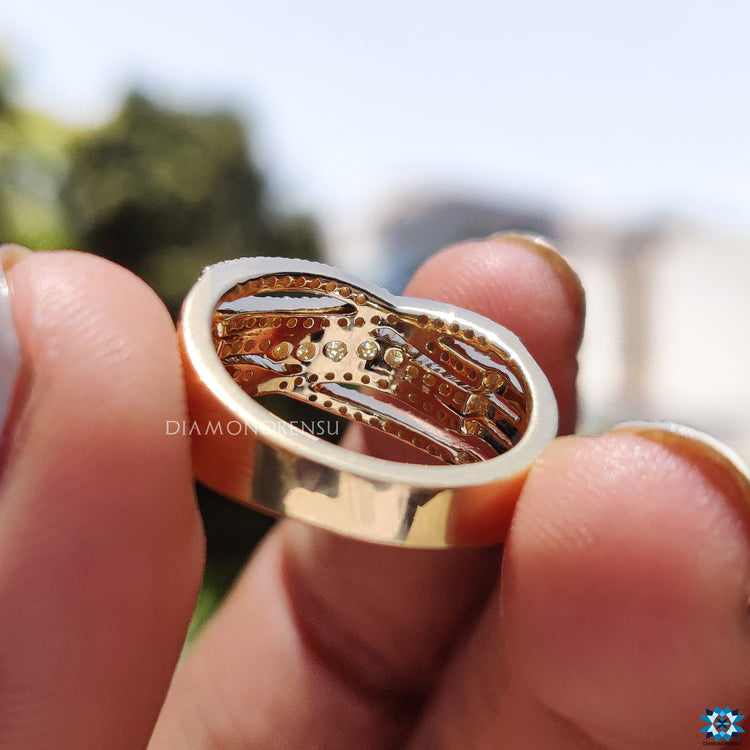 Handmade jewellery ring featuring round moissanite and pave accents.