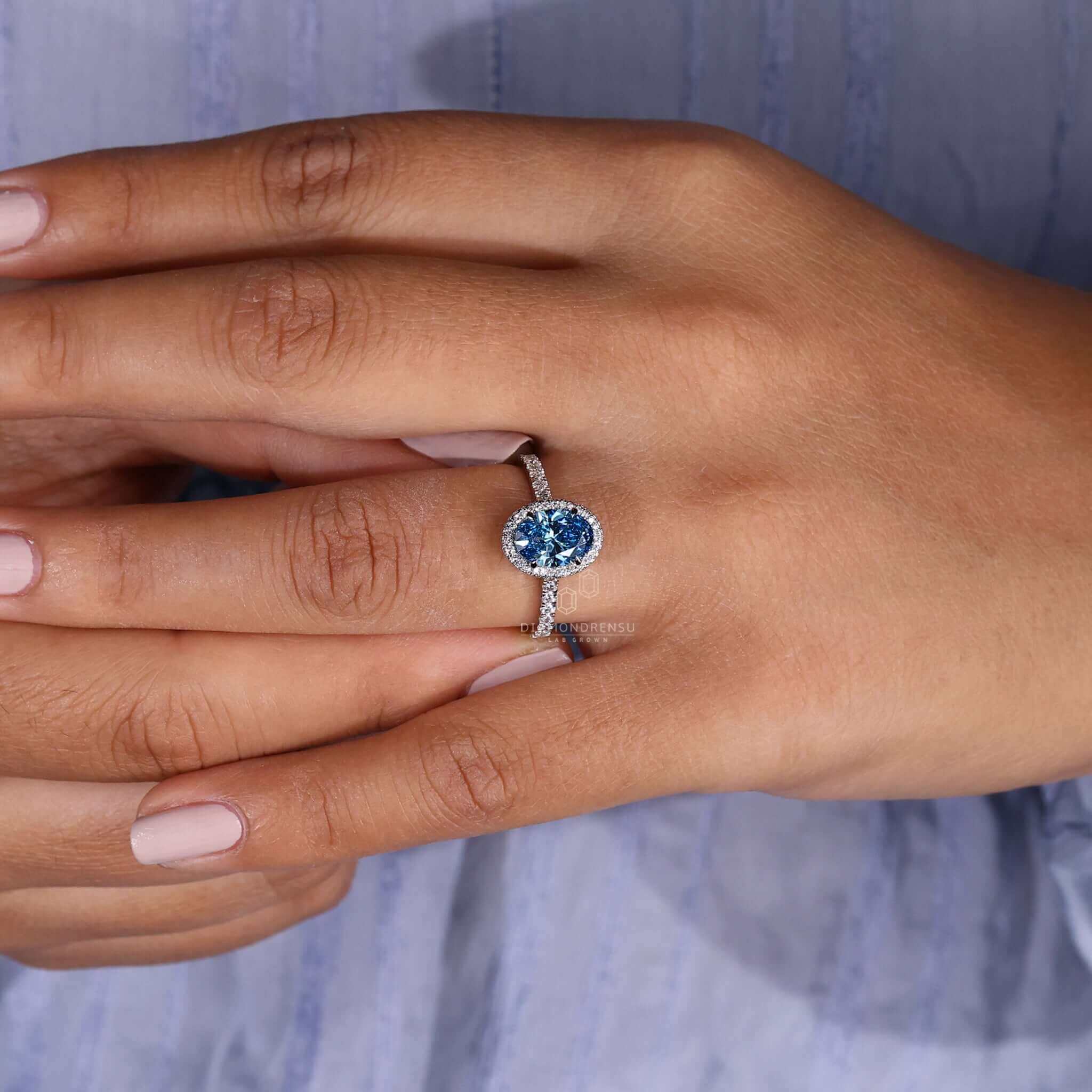 Pave ring diamond set in an oval side stone engagement ring for added elegance and sparkle.