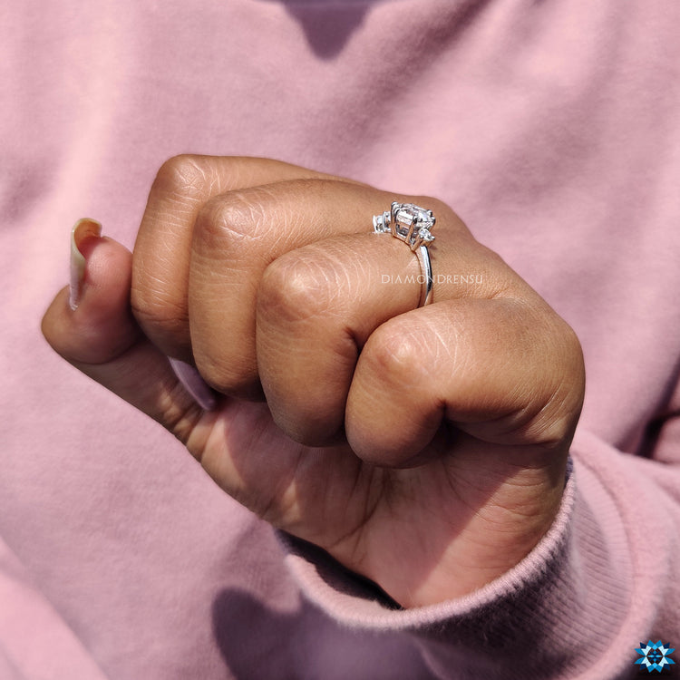 Buy engagement ring featuring hexagon design and brilliant cut side stones.