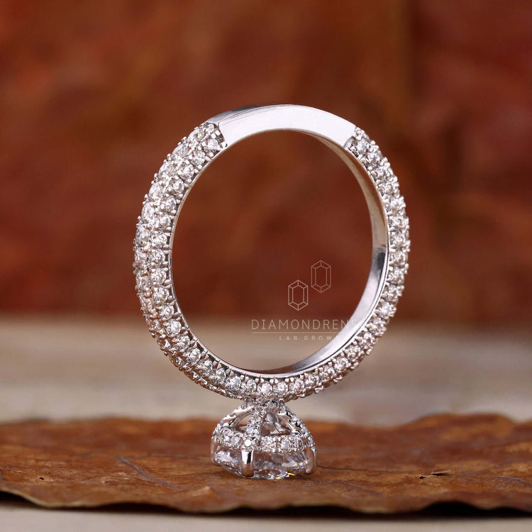 Three pave set engagement ring featuring a hidden halo and igi certified Lab Grown Diamond for sustainable luxury.
