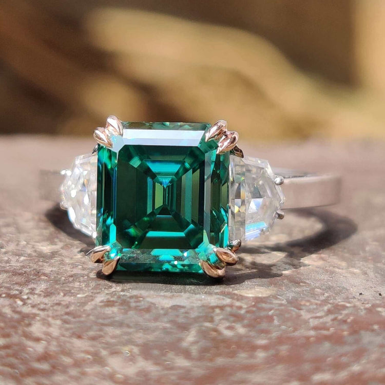 Green Asscher cut moissanite engagement ring in white gold.